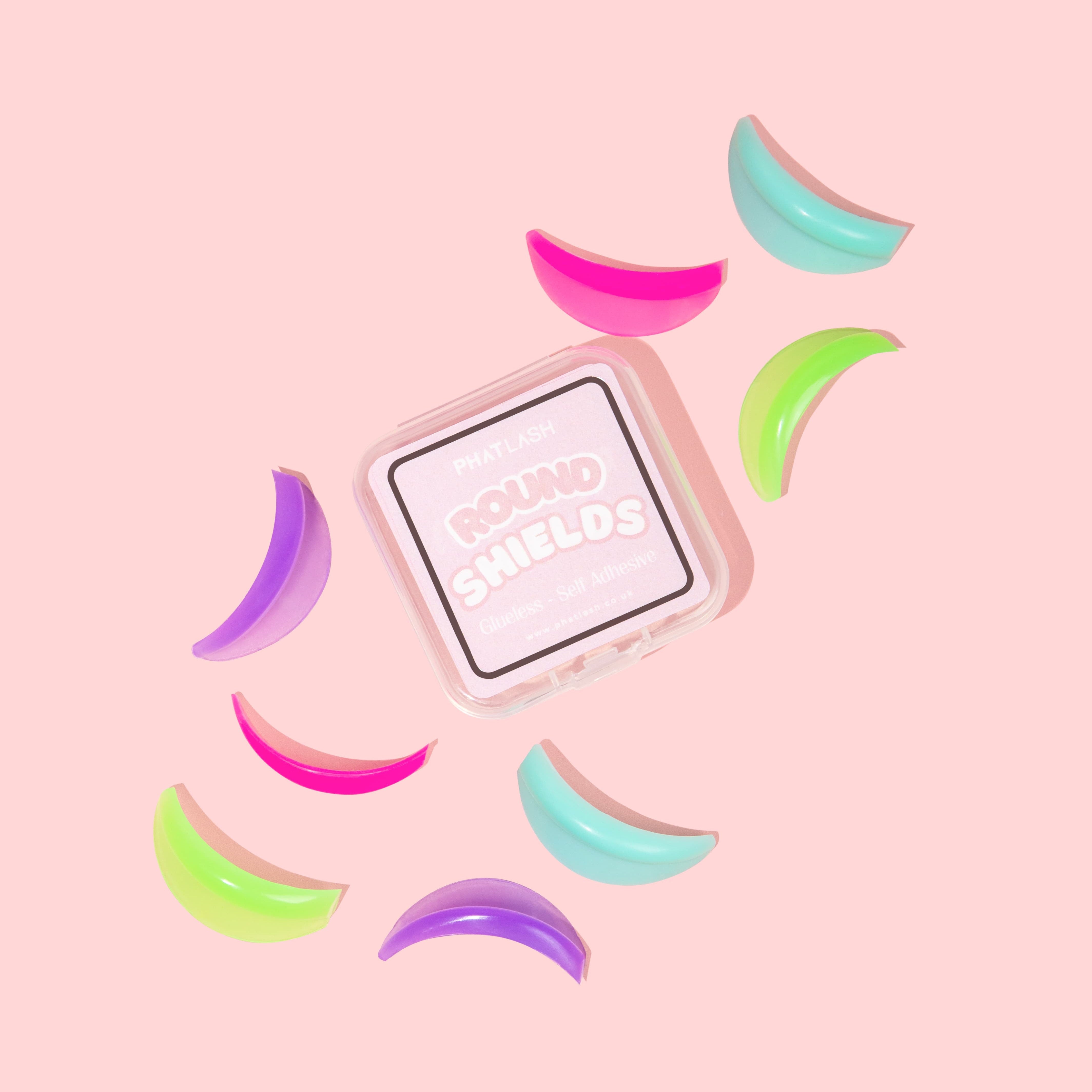 Colorful round lash shields on a pink background with a square container.