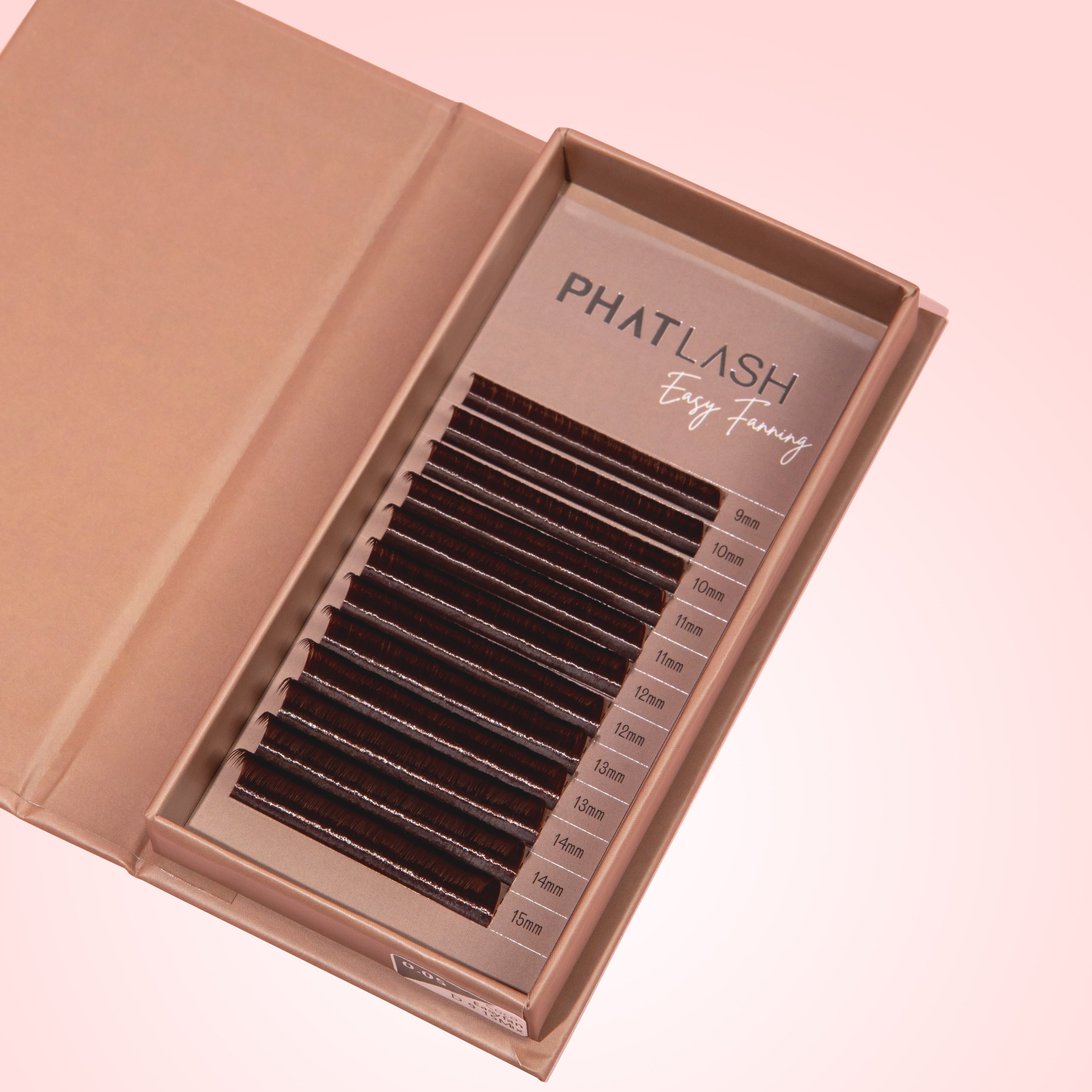 Brown lash tray open on a pink background